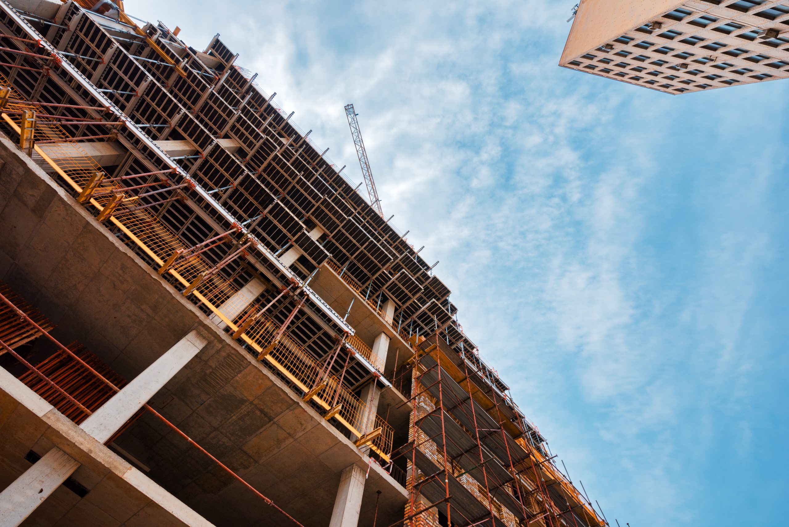 Building construction site with scaffolding gondola