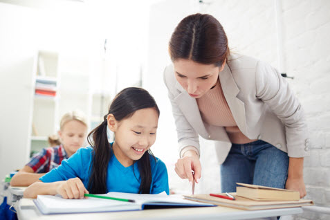 A Chinese tutor examining the student’s work