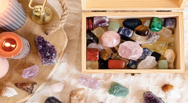 Wooden box filled with various healing crystals