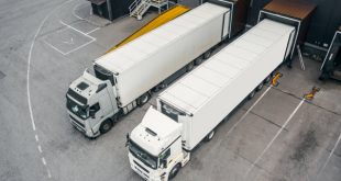 Twp trucks loading cargo in a distribution centre or warehouse