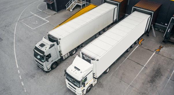 Twp trucks loading cargo in a distribution centre or warehouse