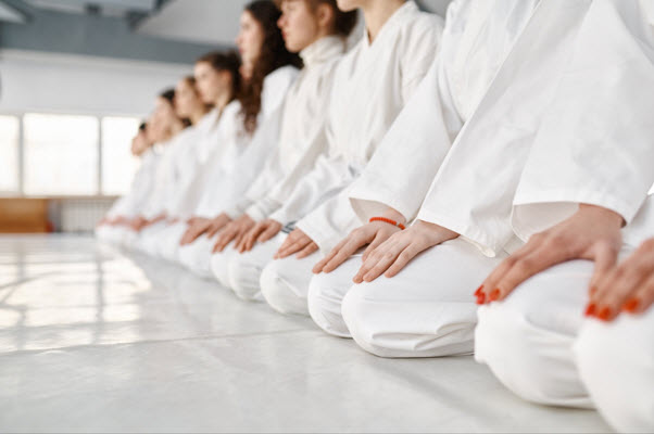 Students sitting in a row at a Taekwondo class