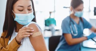 Doctor administering travel vaccine in Singapore