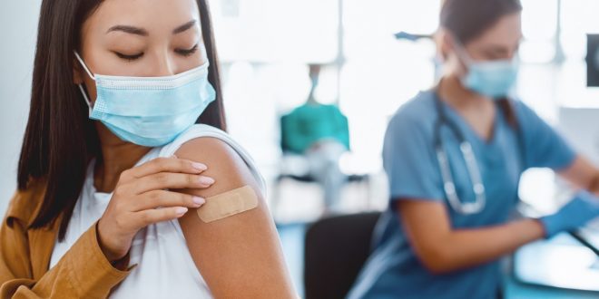 Doctor administering travel vaccine in Singapore