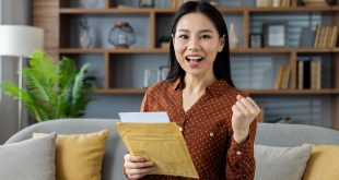 A woman happily holding a document envelope after successful delivery to Malaysia by Evermarch Logistics
