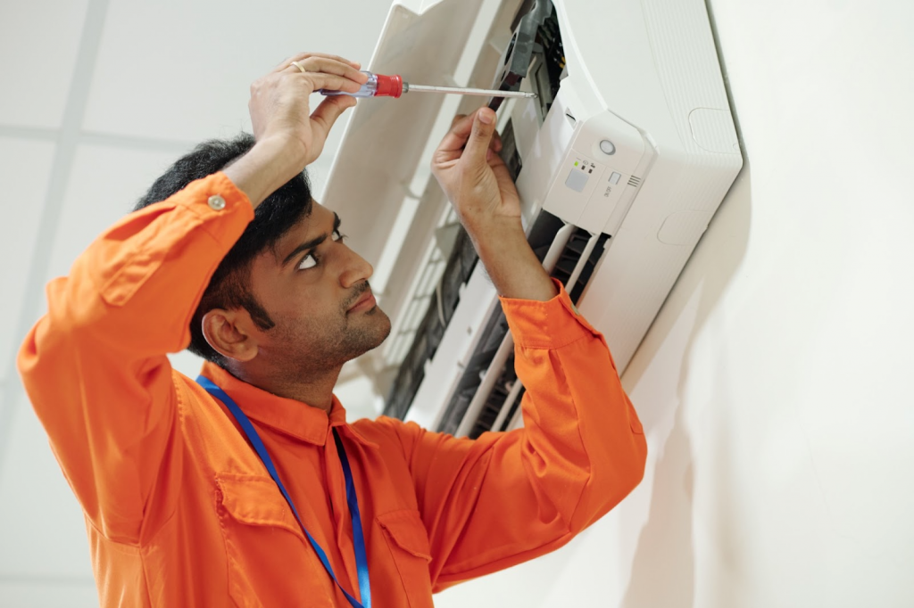 Professional aircon technician performing air conditioner installation service in Singapore