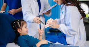 Medical team at a Singapore dental clinic performing an early orthodontic check-up on a child.
