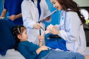 Medical team at a Singapore dental clinic performing an early orthodontic check-up on a child.