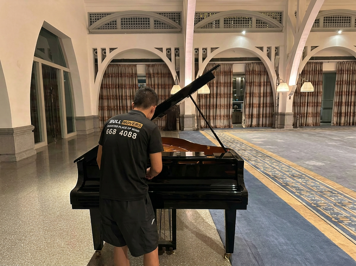 Professional piano moving company in Singapore safely transporting grand piano with expert handling and protective equipment