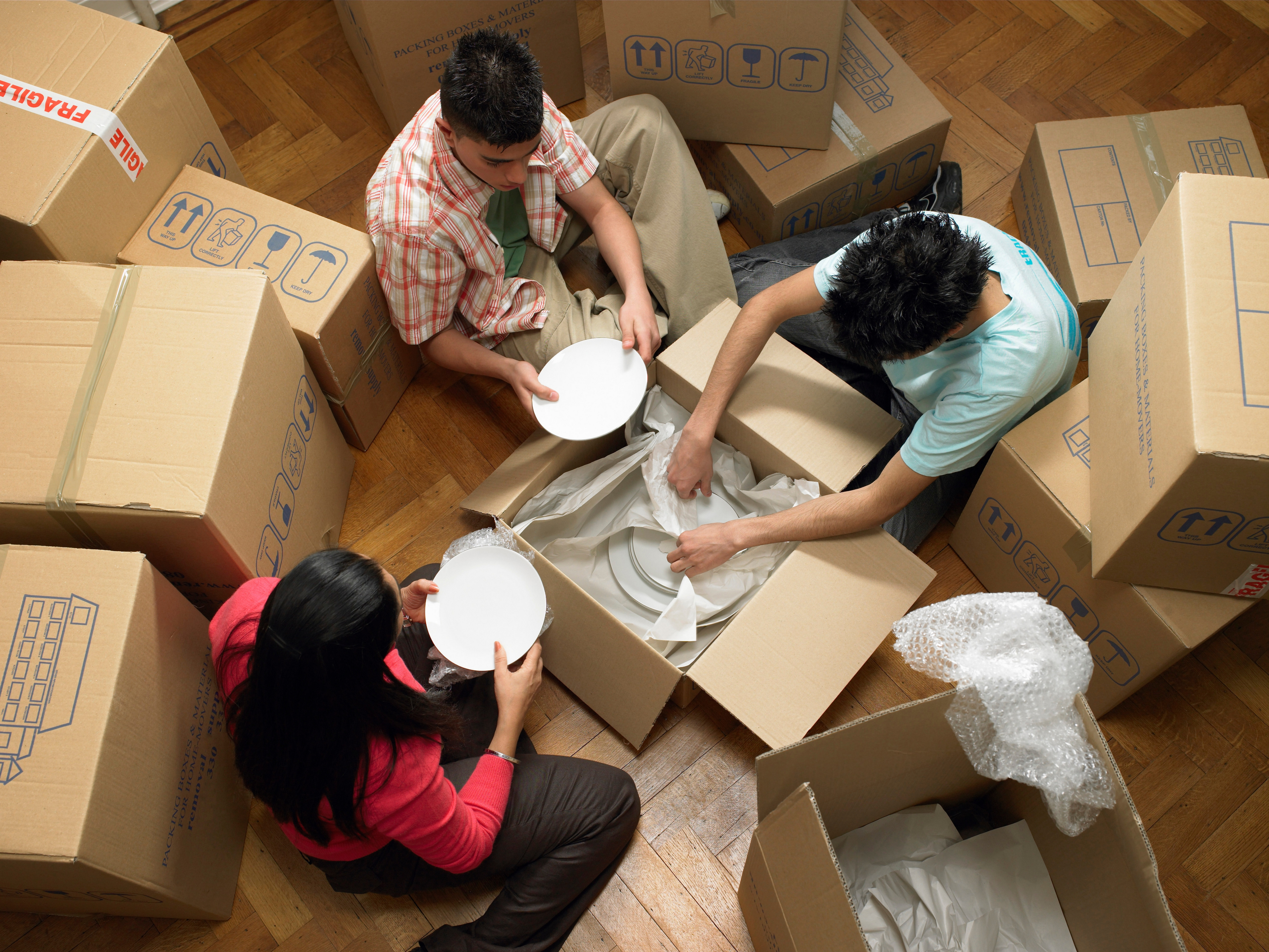 Trusted residential movers safely packing boxes in Singapore home
