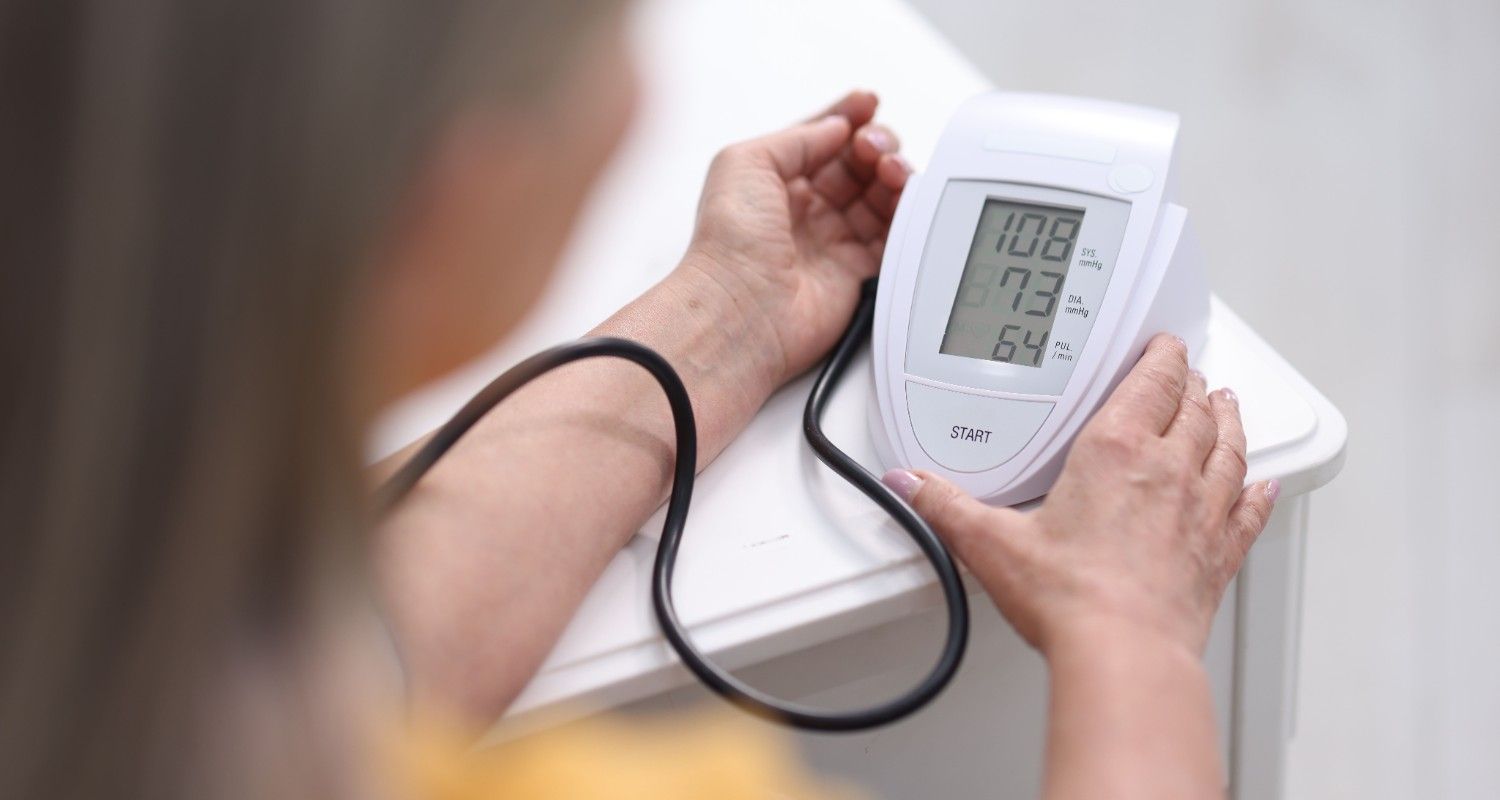 Senior patient undergoing blood pressure screening during annual health check at CHI Health 
