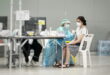 Patient consulting doctor for travel vaccination in Singapore