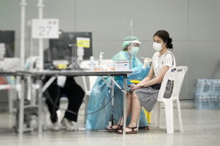 Patient consulting doctor for travel vaccination in Singapore