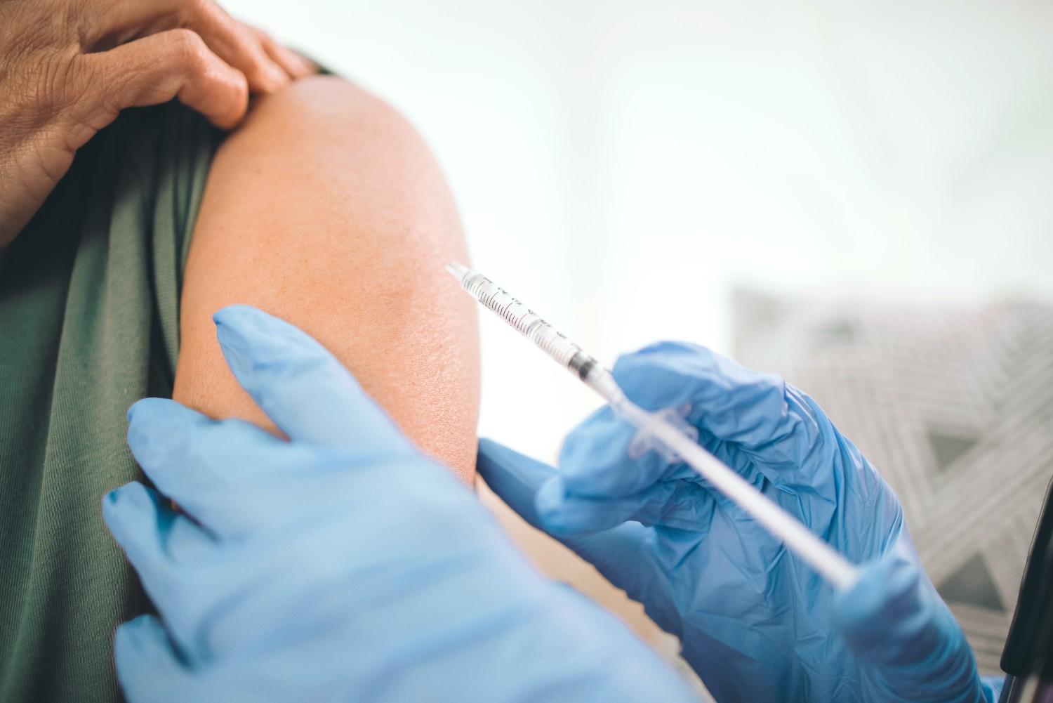 Nurse administering vaccination as part of annual health check and immunisation review in Singapore 
